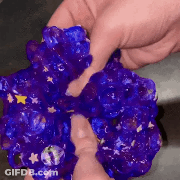 Person Holding Purple Slime With Stars GIF