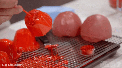 Person Holding Red Candy Stick Zumbos Just Desserts GIF
