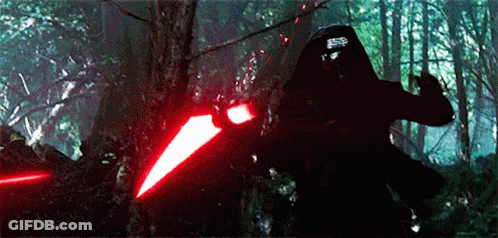 Person Holding Red Light Saber In Forest GIF