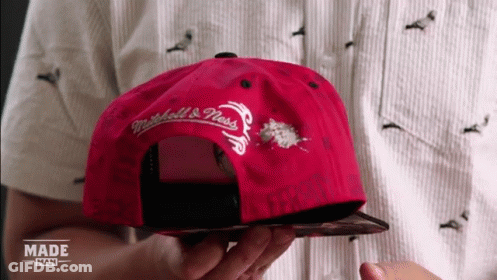 Person Holding Red Mitchell & Ness Hat GIF