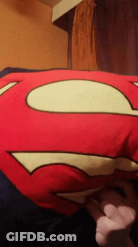 Person Holding Red Superman Pillow GIF