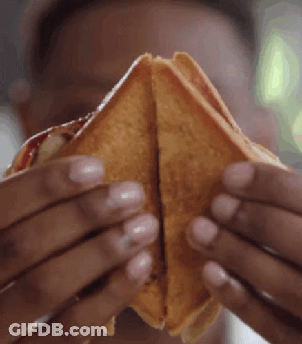 Person Holding Sandwich Halves GIF