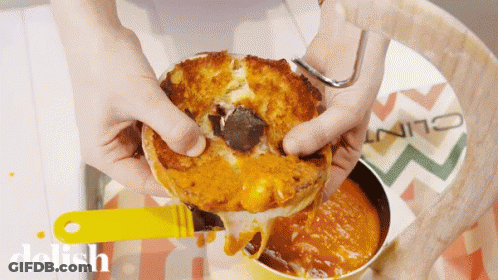 Person Holding Sandwich Near Delish Sauce GIF