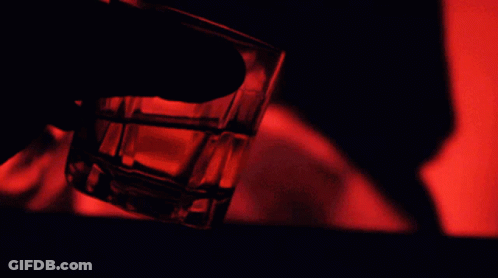 Person Holding Shot Glass With Red Light GIF