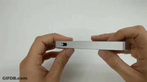 Person Holding Silver Object With Small Hole GIF