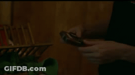 Person Holding Small Device With Pink Screen GIF