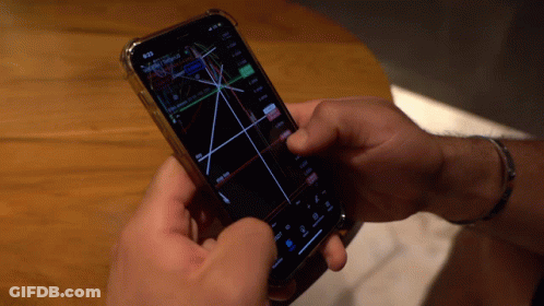 Person Holding Smart Phone With Graph GIF