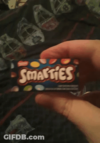 Person Holding Smarties Box GIF