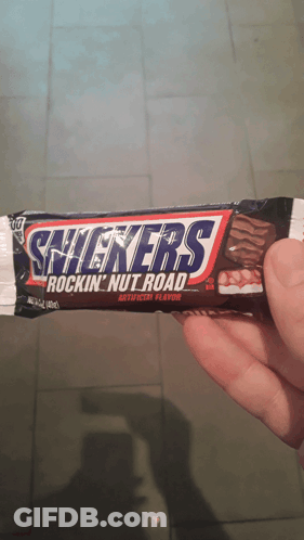 Person Holding Snickers Rockin Nut Road Bar GIF