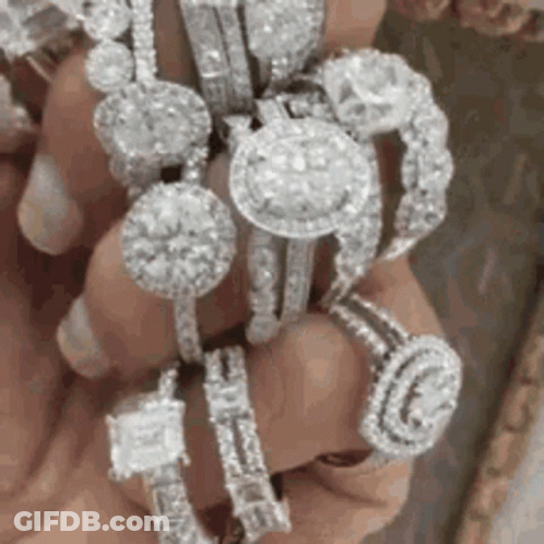 Person Holding Stack Of Rings GIF