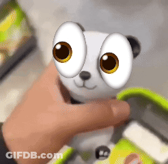 Person Holding Stuffed Animal With Big Yellow Eyes GIF