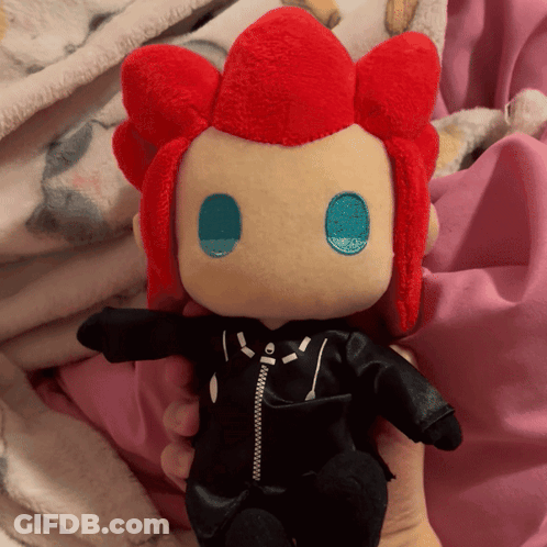 Person Holding Stuffed Doll With Red Hair And Black Jacket GIF