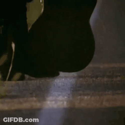 Person Holding Surfboard In Dark Room GIF