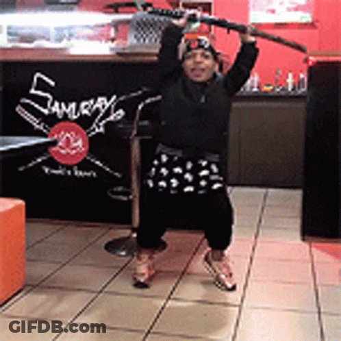 Person Holding Sword In Front Of Samurai Sign GIF