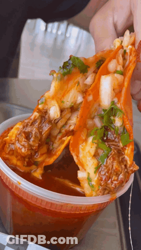 Person Holding Taco Over Sauce GIF