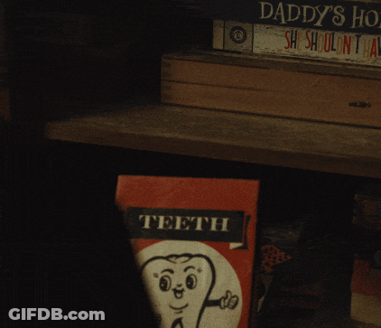 Person Holding Teeth Book With Tooth GIF