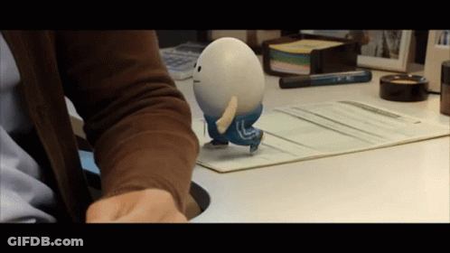 Person Holding Toy With Letter L On Back GIF