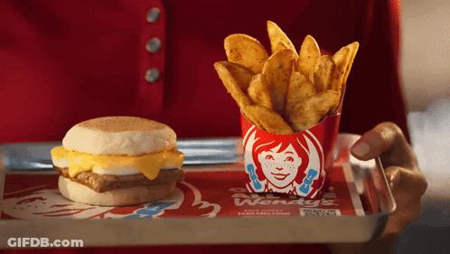 Person Holding Tray With Wendy's Breakfast Sandwich And French Fries GIF