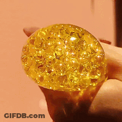 Person Holding Yellow Ball With Sparkles GIF