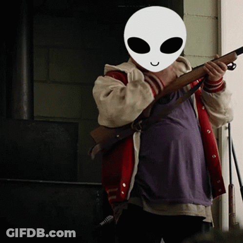 Person In Alien Mask Holding Rifle GIF