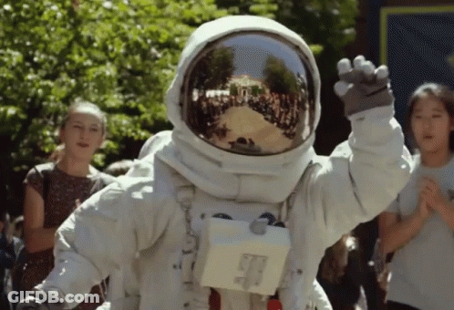 Person In Astronaut Suit Waving GIF