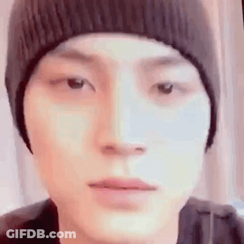 Person In Beanie Looking At Camera GIF