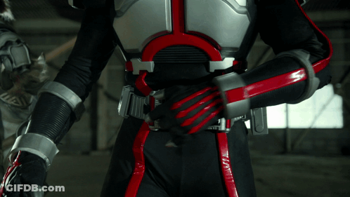 Person In Black And Red Costume With 00000 Belt GIF