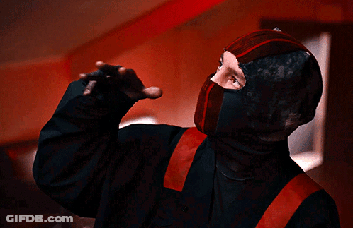Person In Black And Red Costume With Red Belt GIF