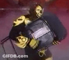 Person In Black And Yellow Costume Holding Black Object GIF
