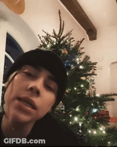 Person In Black Beanie With Christmas Tree GIF