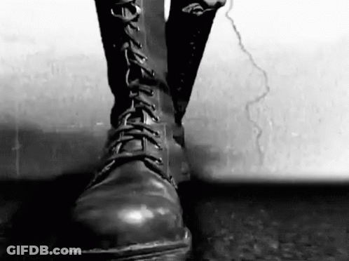 Person In Black Boots On Cracked Sidewalk GIF