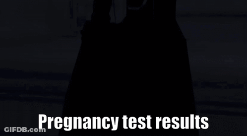 Person In Black Dress In Front Of Pregnancy Test Results Sign GIF