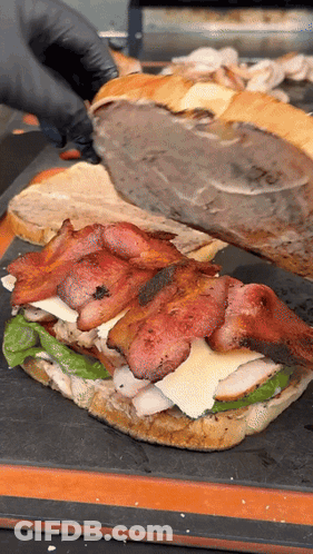 Person In Black Gloves Cutting Sandwich GIF