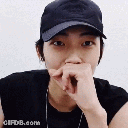 Person In Black Hat Covering Mouth GIF