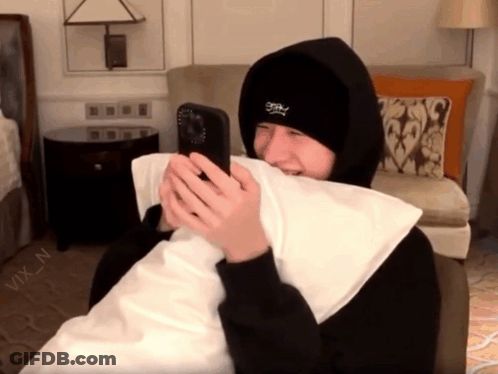 Person In Black Hoodie Holding Phone GIF