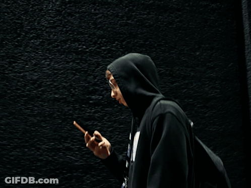 Person In Black Hoodie Talking On Phone GIF