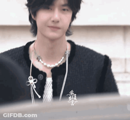 Person In Black Jacket And Pearl Necklace GIF