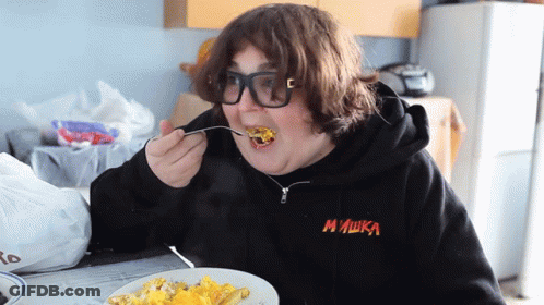 Person In Black Mishka Sweatshirt Eating GIF