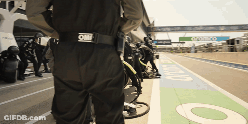 Person In Black Om Jumpsuit In Pit Lane GIF