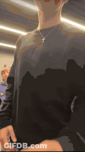 Person In Black Shirt With Cross GIF