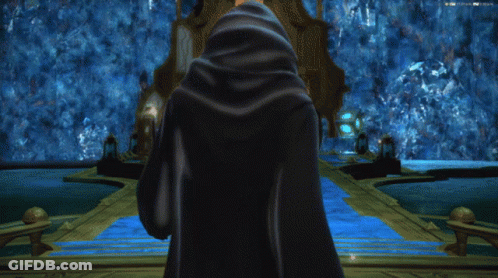Person In Blue Cloak In Front Of Building GIF
