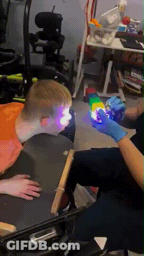 Person In Blue Gloves Holding Cube GIF