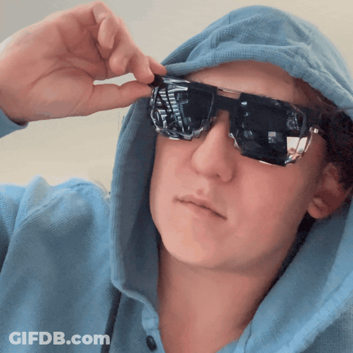 Person In Blue Hoodie And Sunglasses Taking Picture GIF