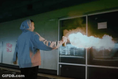 Person In Blue Hoodie Spray Painting Building GIF