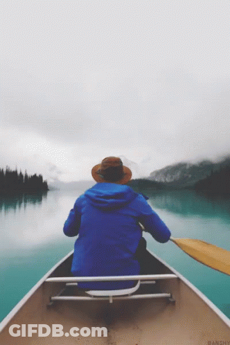 Person In Blue Jacket And Hat In Canoe GIF