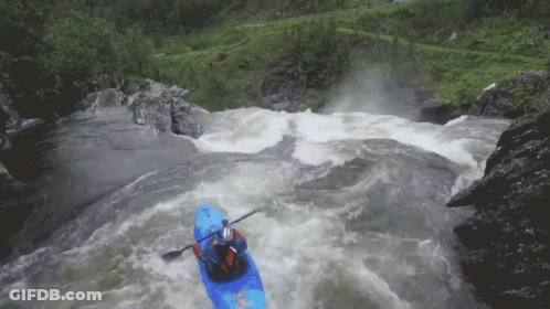 Person In Blue Kayak Paddling Down River GIF