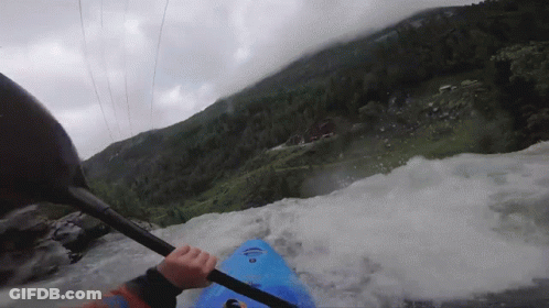 Person In Blue Kayak Paddling Through Rapid GIF