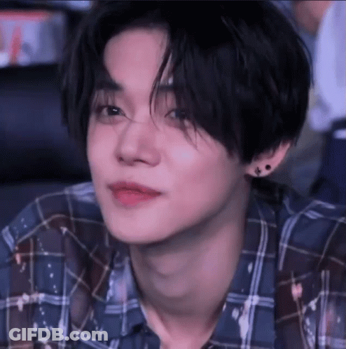 Person In Blue Plaid Shirt And Earrings GIF