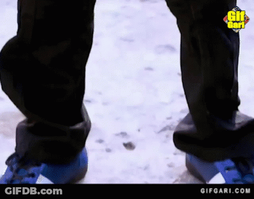 Person In Blue Shoes Standing In Snow GIF