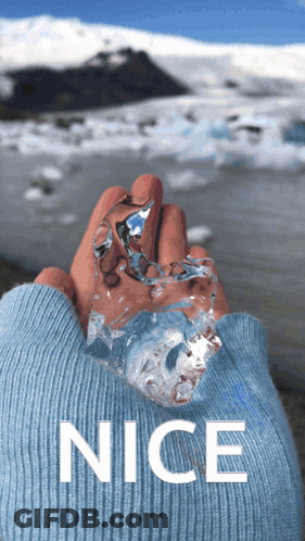 Person In Blue Sweater Holding Ice GIF